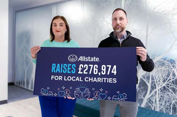 ANI employees hold up a sign stating Allstate raises £276,974 for local charities. 