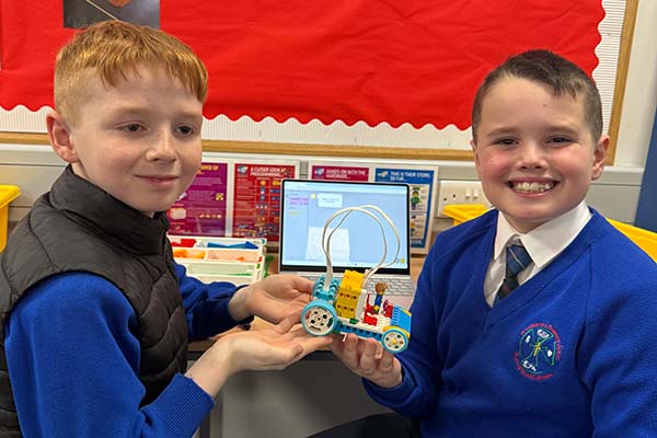 Young boys work together in making a lego taxi. 