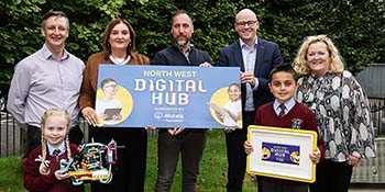 Allstate Ni employees holds a sign that says North West Digital Hub. Childeren showing their innovation from the competition. 