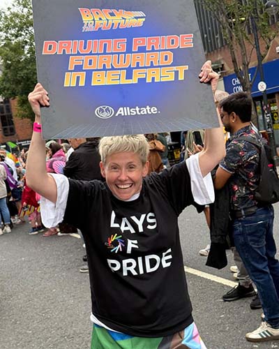 ANI employee holding a sign - Driving Pride forward in Belfast.