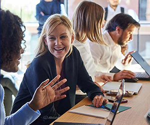 A group of employees talking with one another. 