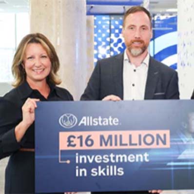 Allstate NI employees holds sign that says Allstate invested &pound;16 million in skills. 